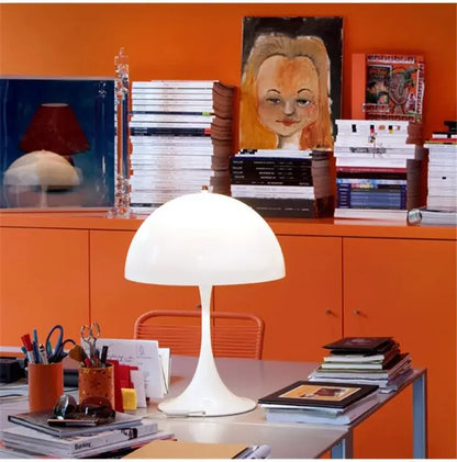 Minimalist LED mushroom lamp on desk in modern colorful office or study room.