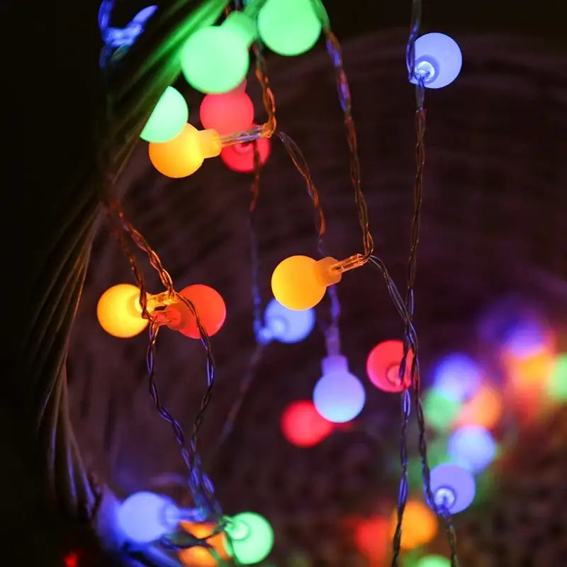 Colorful LED ball string lights creating a magical and warm ambiance in a wicker basket.